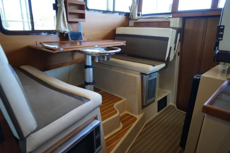 Slide: The Image of Interior of 2014 Ranger Tugs R-31 boat with seating and wooden table. - 37