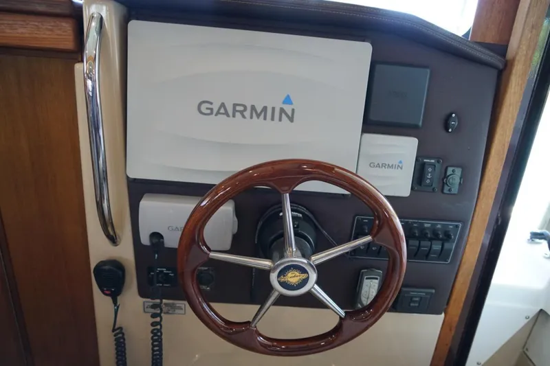 Slide: The Image of 2014 Ranger Tugs R-31 helm with Garmin navigation system and wooden steering wheel. - 40