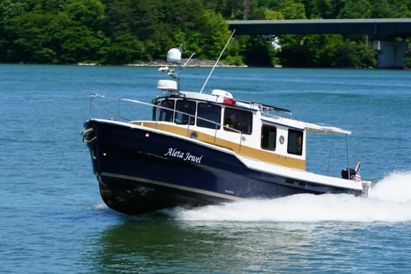 Slide: The Image of 2014 Ranger Tugs R-31 boat cruising on a scenic lake. - 7