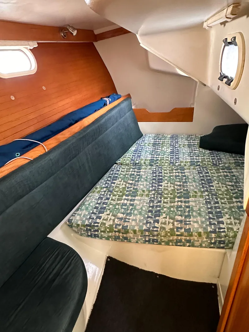 Slide: The Image of Interior cabin of a 2000 Catalina 320 sailboat with bed and seating area. - 12