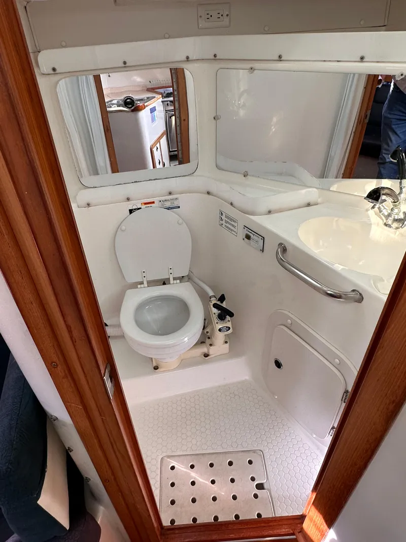 Slide: The Image of 2000 Catalina 320 boat bathroom with toilet and sink - 3