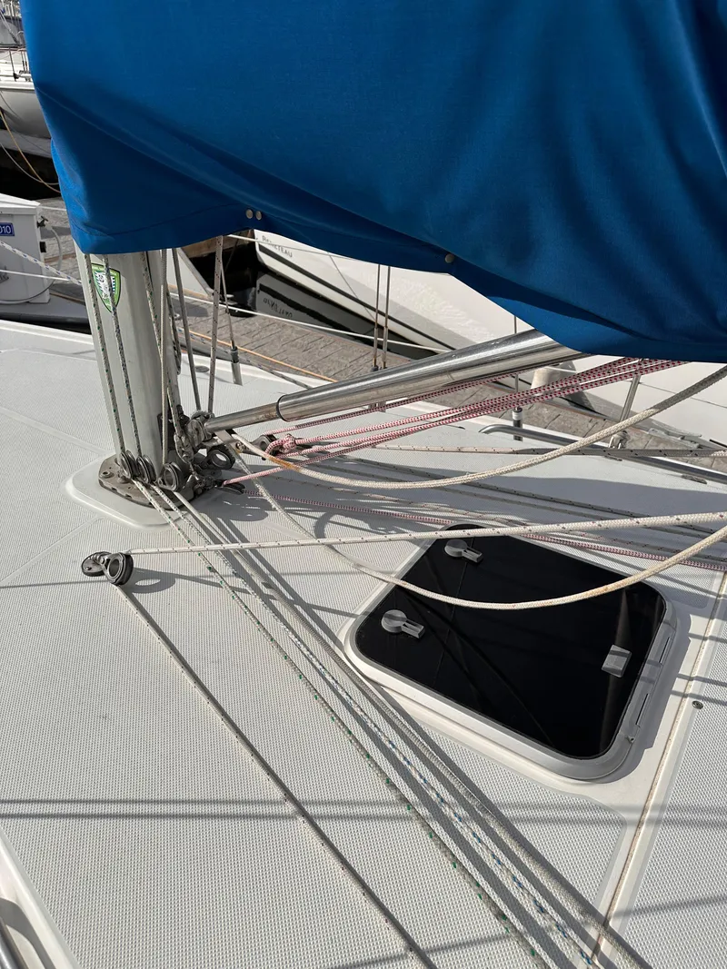 Slide: The Image of Close-up of a 2000 Catalina 320 sailboat deck with rigging and hatch. - 5
