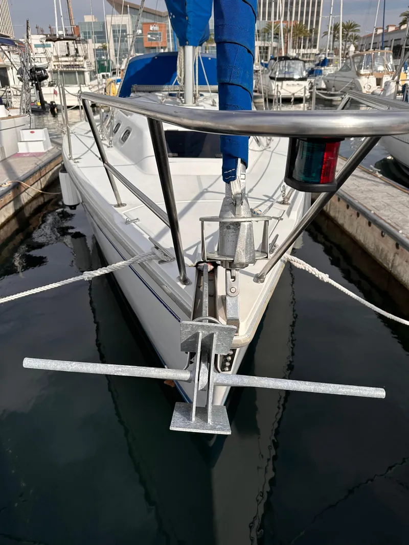 Slide: The Image of Catalina 320 sailboat, 2000 model, docked at a marina with blue sail covers. - 8