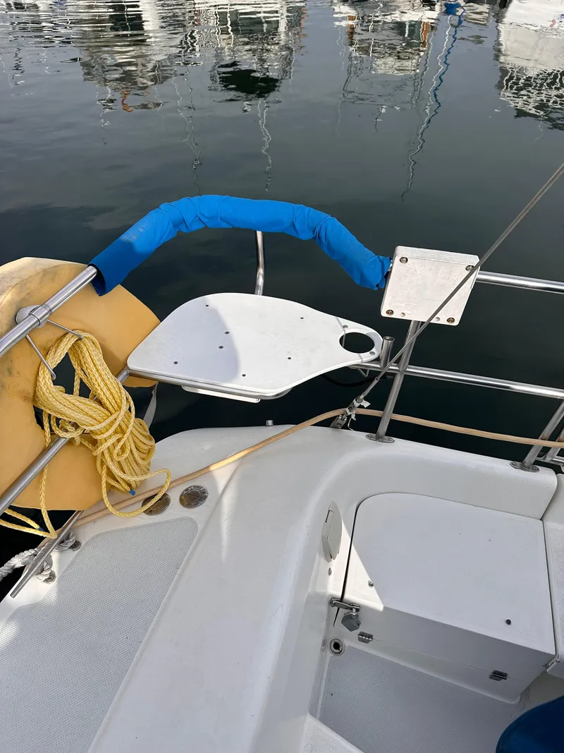 Slide: The Image of Cockpit of a 2000 Catalina 320 sailboat docked at a marina. - 9