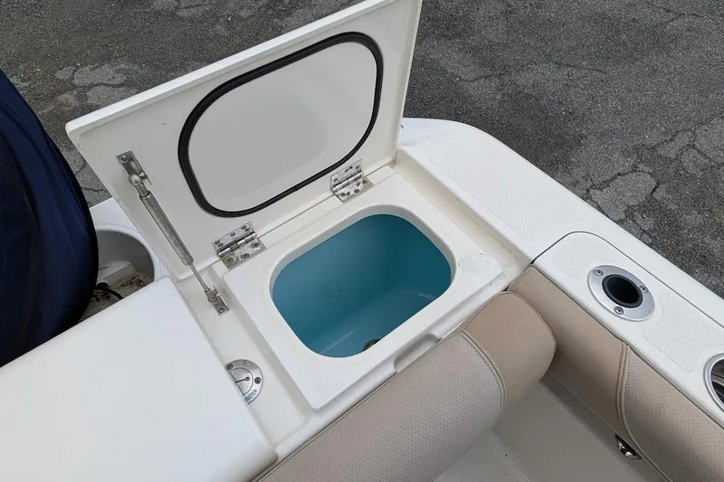 Slide: The Image of Open storage compartment on 2011 Pursuit DC 265 Dual Console boat. - 11