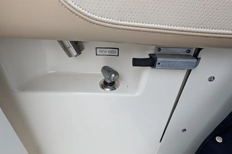 Slide: The Image of Fresh water access on 2011 Pursuit DC 265 Dual Console boat interior. - 12