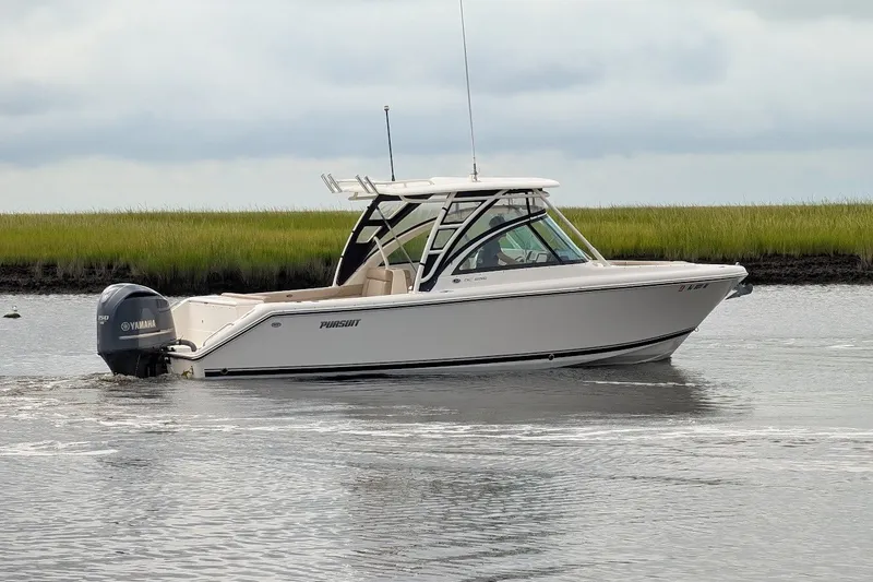 Slide: The Image of 2011 Pursuit DC 265 Dual Console boat on calm water with Yamaha engine. - 6