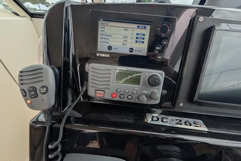 Slide: The Image of Control panel of a 2011 Pursuit DC 265 Dual Console boat with Yamaha display. - 24