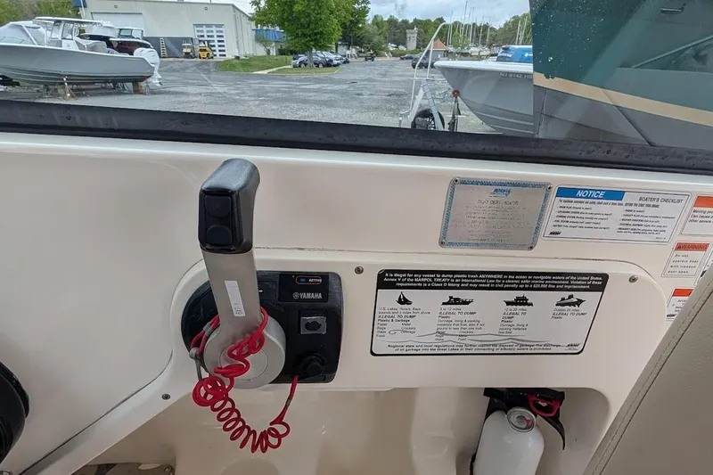 Slide: The Image of Control panel of a 2011 Pursuit DC 265 Dual Console boat with safety notices. - 25