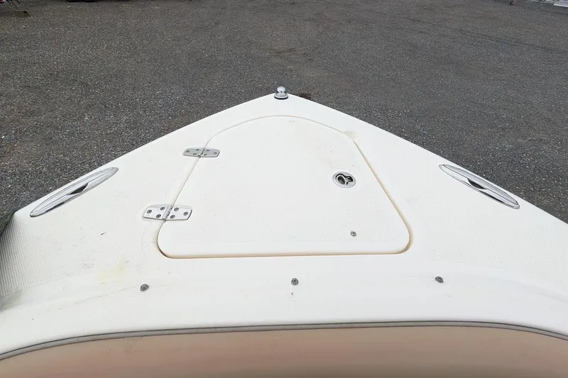 Slide: The Image of Bow view of 2011 Pursuit DC 265 Dual Console boat on gravel surface. - 29