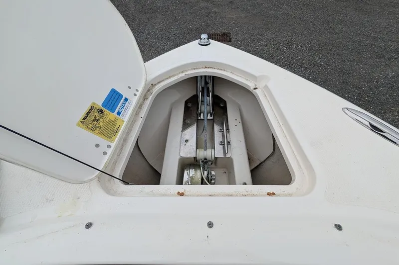Slide: The Image of Anchor compartment of a 2011 Pursuit DC 265 Dual Console boat, open and visible. - 30