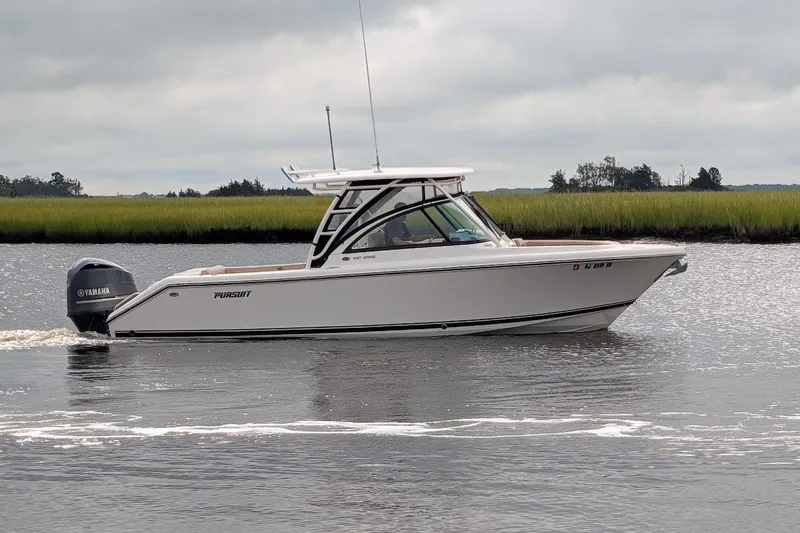 The Image of 2011 Pursuit DC 265 Dual Console boat cruising on a calm river with Yamaha engine. - 0