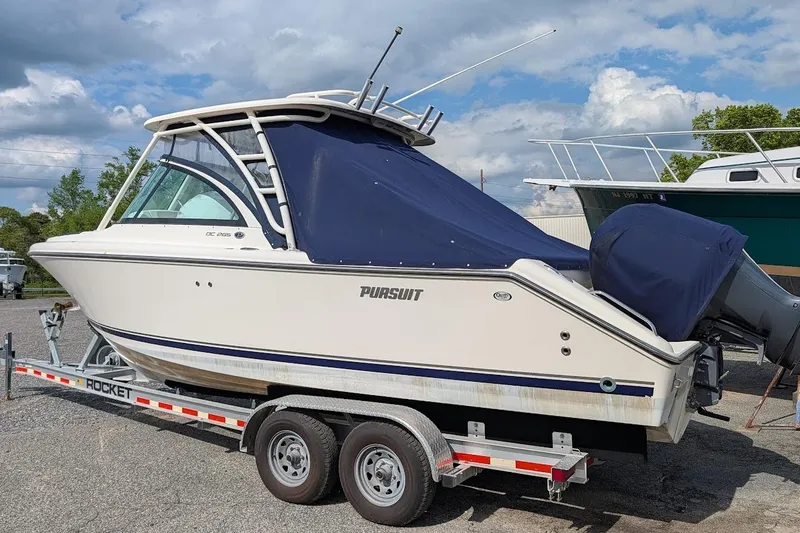 Slide: The Image of 2011 Pursuit DC 265 Dual Console boat on trailer, covered and ready for transport. - 4