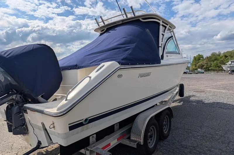 Slide: The Image of 2011 Pursuit DC 265 Dual Console boat on trailer, covered and ready for transport. - 6