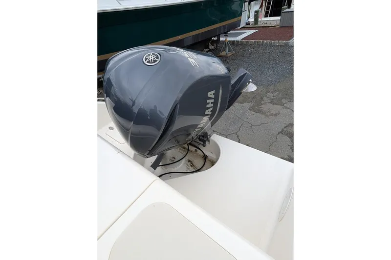 Slide: The Image of 2011 Pursuit DC 265 Dual Console with Yamaha outboard motor, docked on pavement. - 7