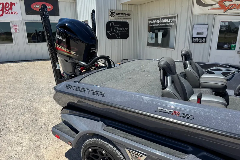 Slide: The Image of 2020 Skeeter FXR21 Apex boat with Yamaha engine, parked outside a dealership. - 1