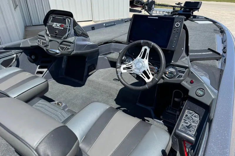 Slide: The Image of 2020 Skeeter FXR21 Apex boat interior with advanced navigation and control systems. - 3