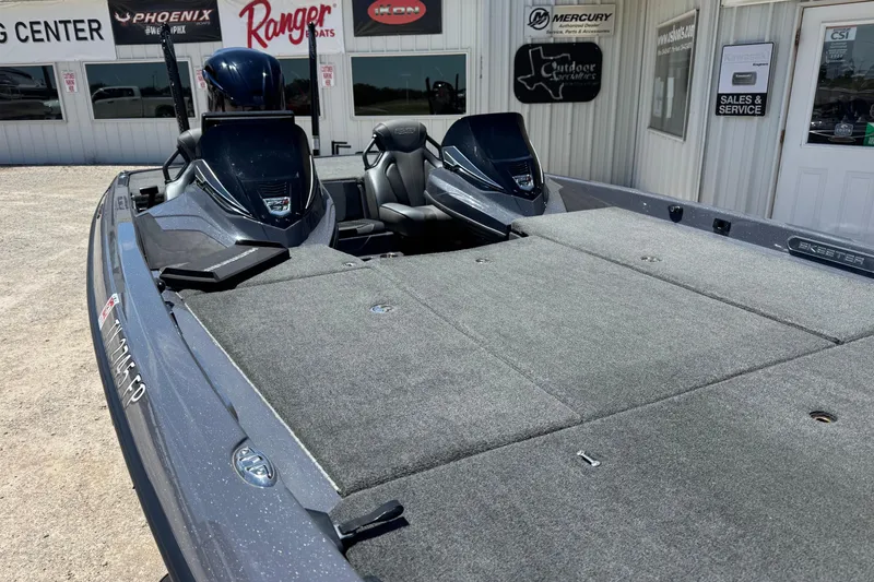 Slide: The Image of 2020 Skeeter FXR21 Apex boat at dealership, showcasing spacious deck and seating. - 5