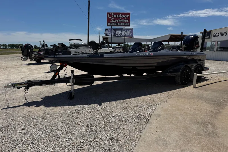 Slide: The Image of 2020 Skeeter FXR21 Apex boat on trailer at dealership under clear sky. - 6