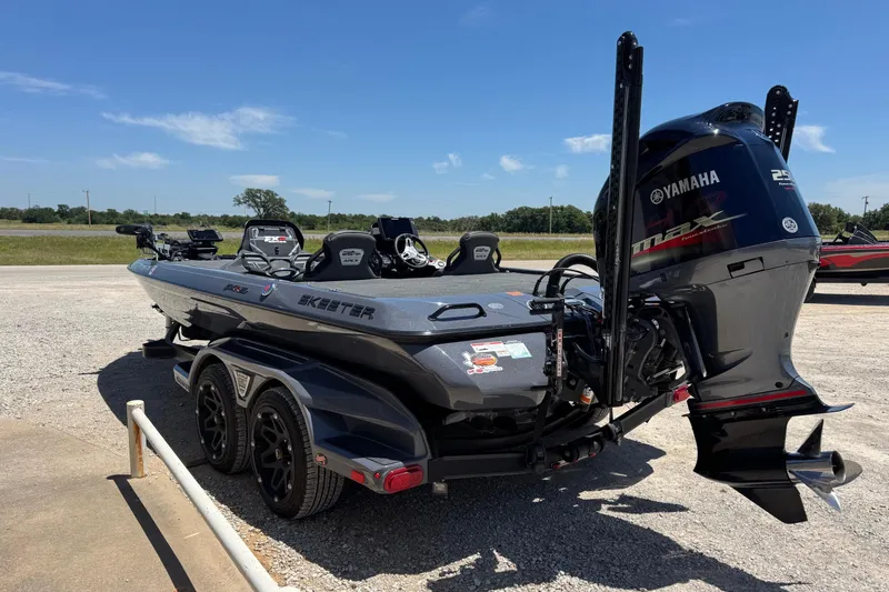 Slide: The Image of 2020 Skeeter FXR21 Apex boat with Yamaha engine on a trailer, parked outdoors. - 8