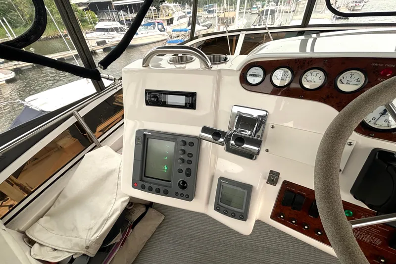 Slide: The Image of Helm of 2000 Silverton 422 Motor Yacht with navigation instruments and controls. - 26