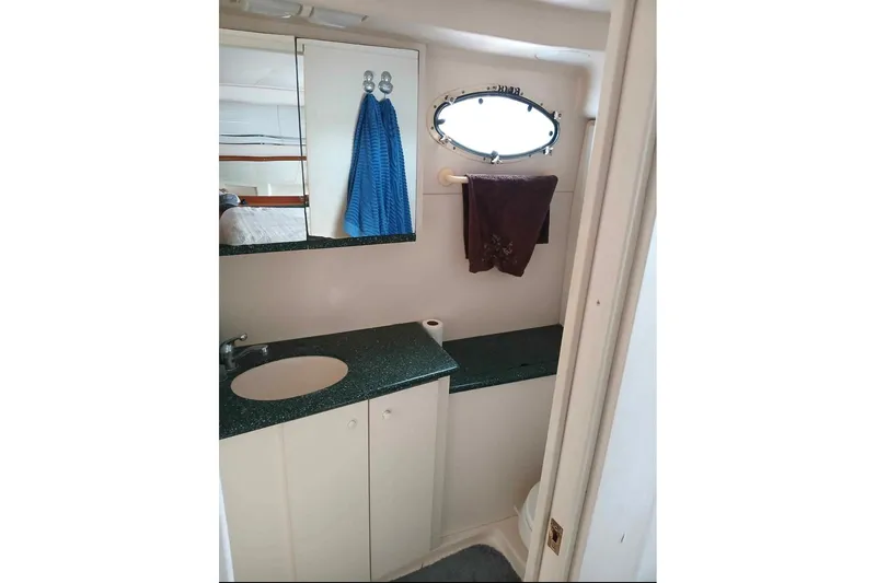 Slide: The Image of Bathroom interior of 2000 Silverton 422 Motor Yacht with sink and mirror. - 12