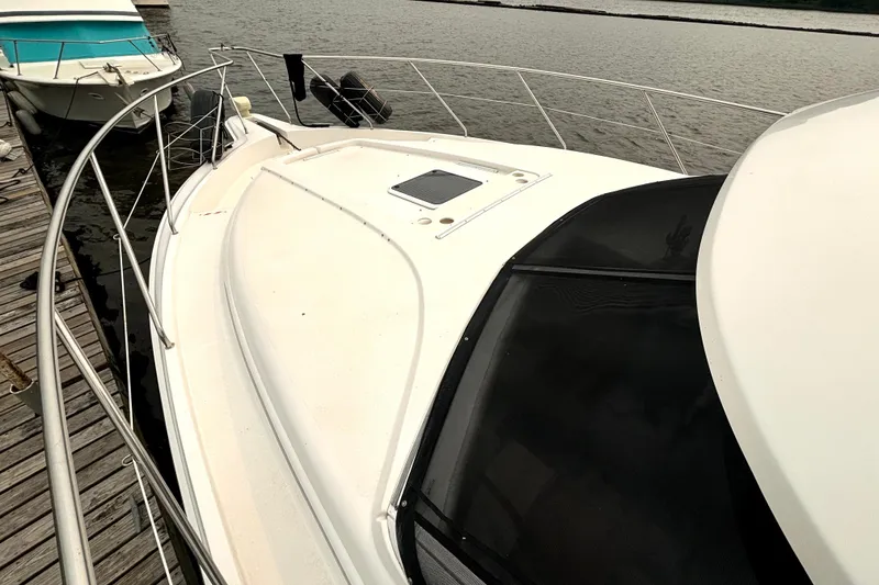 Slide: The Image of 2000 Silverton 422 Motor Yacht docked, showcasing sleek design and spacious deck. - 11