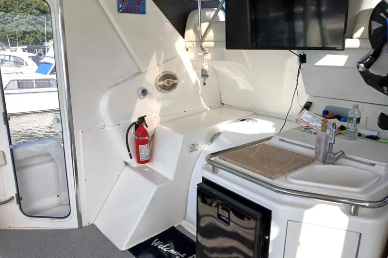 Slide: The Image of Interior of 2000 Silverton 422 Motor Yacht with kitchenette and fire extinguisher. - 3