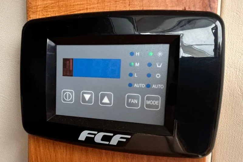 Slide: The Image of Control panel of a 2000 Silverton 422 Motor Yacht, featuring FCF display. - 51