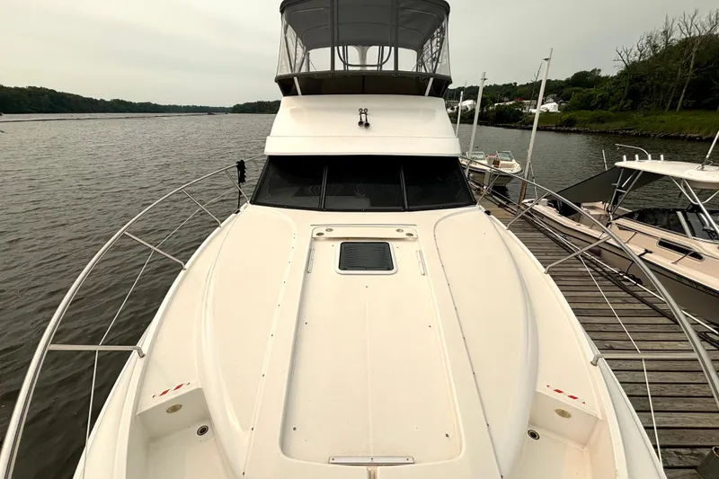 Slide: The Image of 2000 Silverton 422 Motor Yacht docked on a calm river. - 13