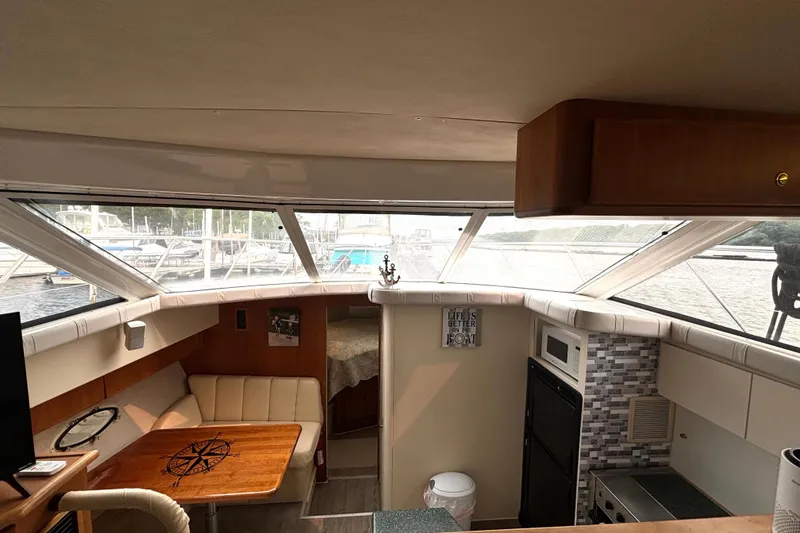 Slide: The Image of Interior of 2000 Silverton 422 Motor Yacht with dining area and kitchenette. - 34