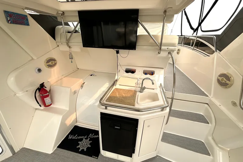 Slide: The Image of Interior of 2000 Silverton 422 Motor Yacht with kitchenette and TV. - 18