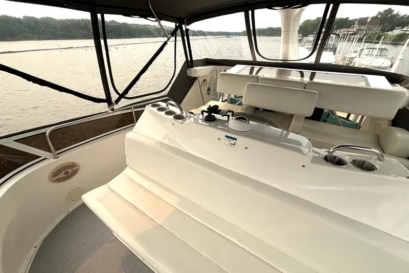 Slide: The Image of 2000 Silverton 422 Motor Yacht interior with helm, overlooking serene waters. - 23