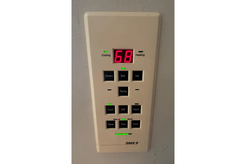 Slide: The Image of Thermostat control panel on 2000 Silverton 422 Motor Yacht, displaying temperature settings. - 49