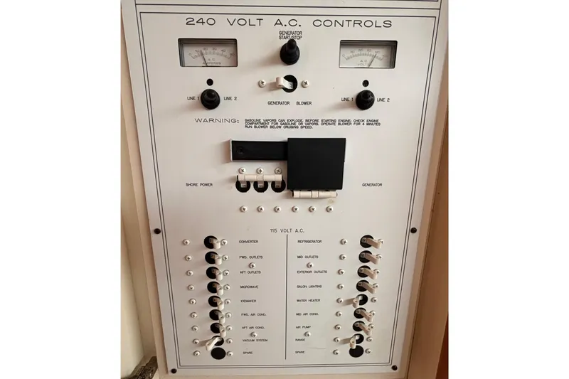 Slide: The Image of Control panel of a 2000 Silverton 422 Motor Yacht, featuring 240V AC controls and switches. - 53