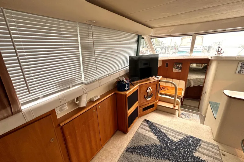 Slide: The Image of Interior of 2000 Silverton 422 Motor Yacht with cozy living area and nautical decor. - 32