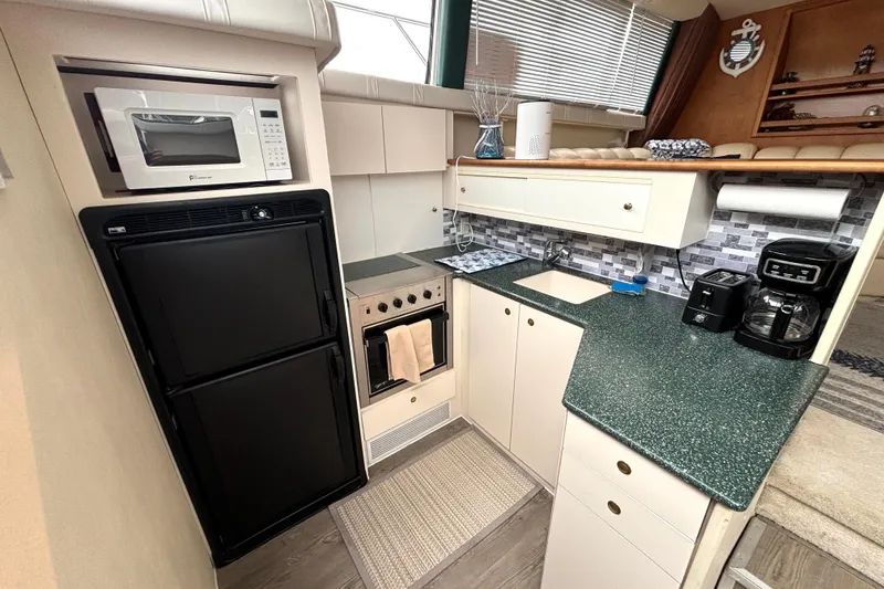 Slide: The Image of Kitchen area of a 2000 Silverton 422 Motor Yacht with modern appliances. - 36