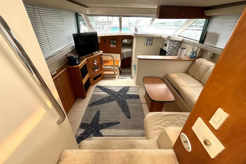 Slide: The Image of Interior of 2000 Silverton 422 Motor Yacht with cozy seating and nautical decor. - 30