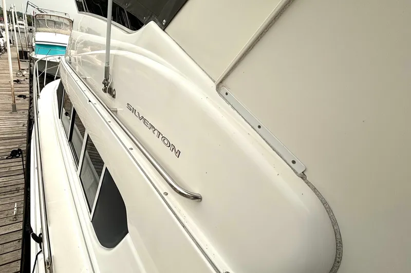 Slide: The Image of 2000 Silverton 422 Motor Yacht docked at marina, side view. - 7
