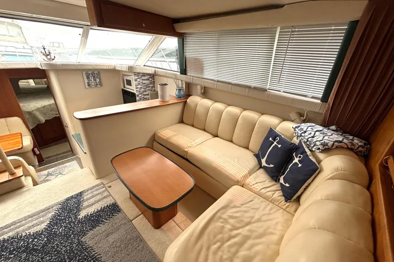 Slide: The Image of Interior of 2000 Silverton 422 Motor Yacht with cozy seating and nautical decor. - 31