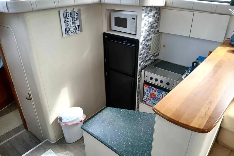 Slide: The Image of Interior of 2000 Silverton 422 Motor Yacht kitchen with appliances and decor. - 8