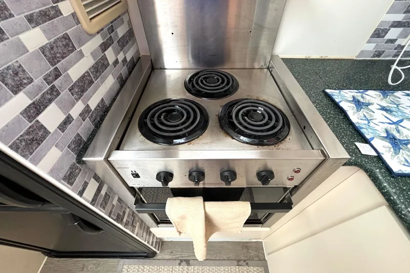 Slide: The Image of Electric stove in 2000 Silverton 422 Motor Yacht kitchen with tiled backsplash. - 37