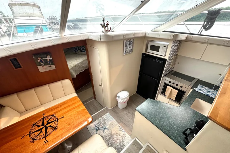 Slide: The Image of Interior of 2000 Silverton 422 Motor Yacht with kitchen and seating area. - 35