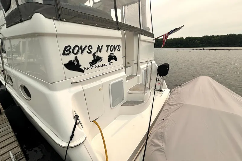 Slide: The Image of Silverton 422 Motor Yacht 2000 docked, featuring "Boys N Toys" signage, East Nassau, NY. - 9
