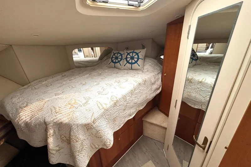 Slide: The Image of Cozy bedroom in 2000 Silverton 422 Motor Yacht with nautical-themed decor and mirrored door. - 39