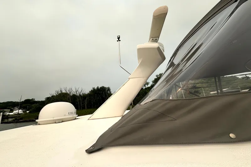 Slide: The Image of 2000 Silverton 422 Motor Yacht deck with radar and antenna, overcast sky. - 10