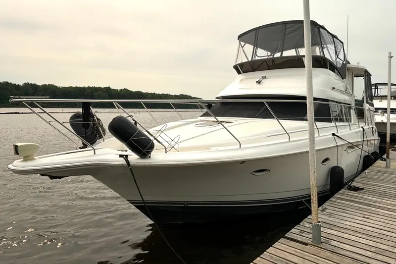 The Image of 2000 Silverton 422 Motor Yacht docked at a marina, side view. - 2
