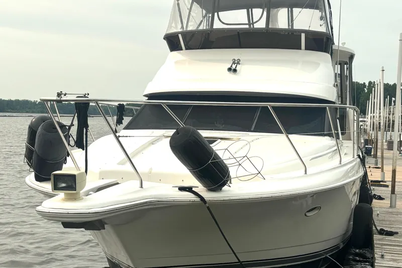 Slide: The Image of 2000 Silverton 422 Motor Yacht docked at marina, front view. - 6