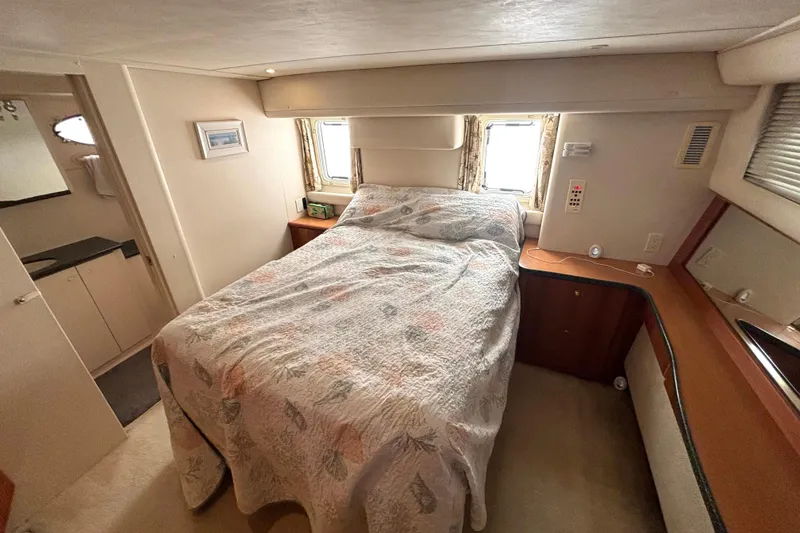 Slide: The Image of Cozy bedroom interior of 2000 Silverton 422 Motor Yacht with bed and window view. - 42