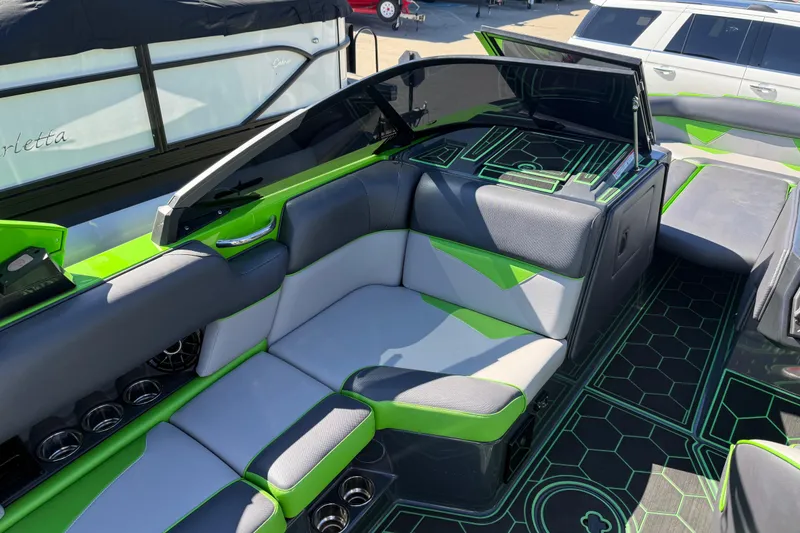 Slide: The Image of 2022 Moomba Makai boat interior with green and gray seating, modern design. - 10